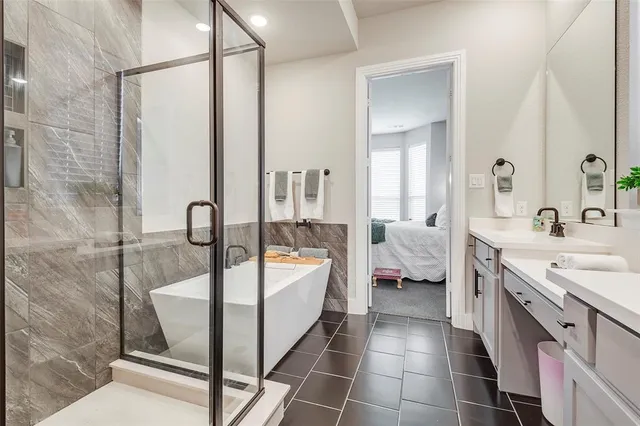 a spacious bathroom with a double vanity sink a mirror and a bathtub