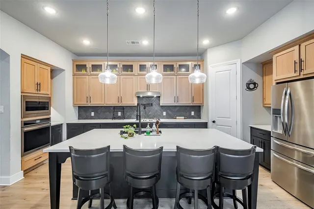 a kitchen with a table and chairs in it