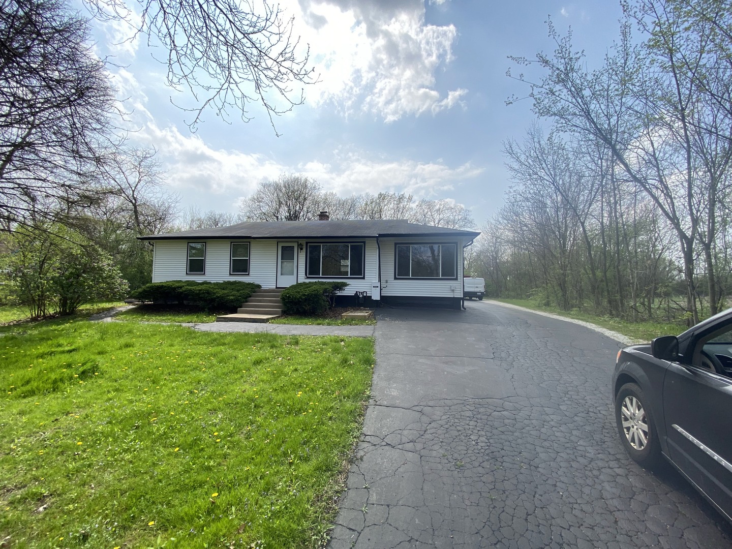 a view of a house with a yard and sitting area