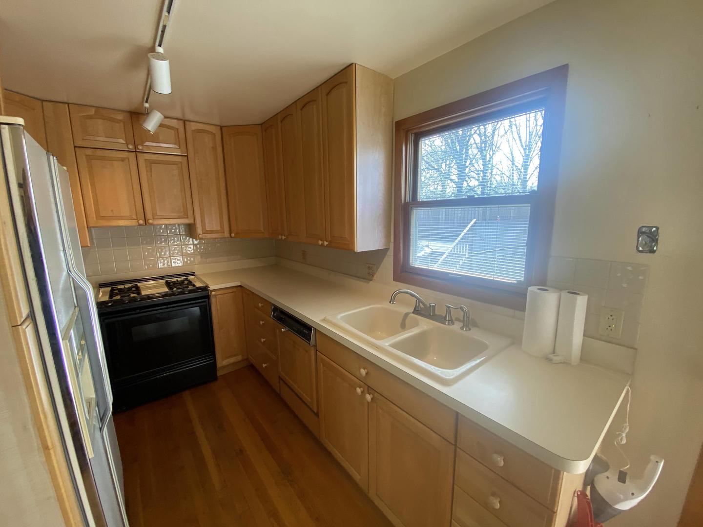 11270 Bell Road Lemont, IL 60439 - Photo 3 of 23 a kitchen with a sink a stove a refrigerator and a window