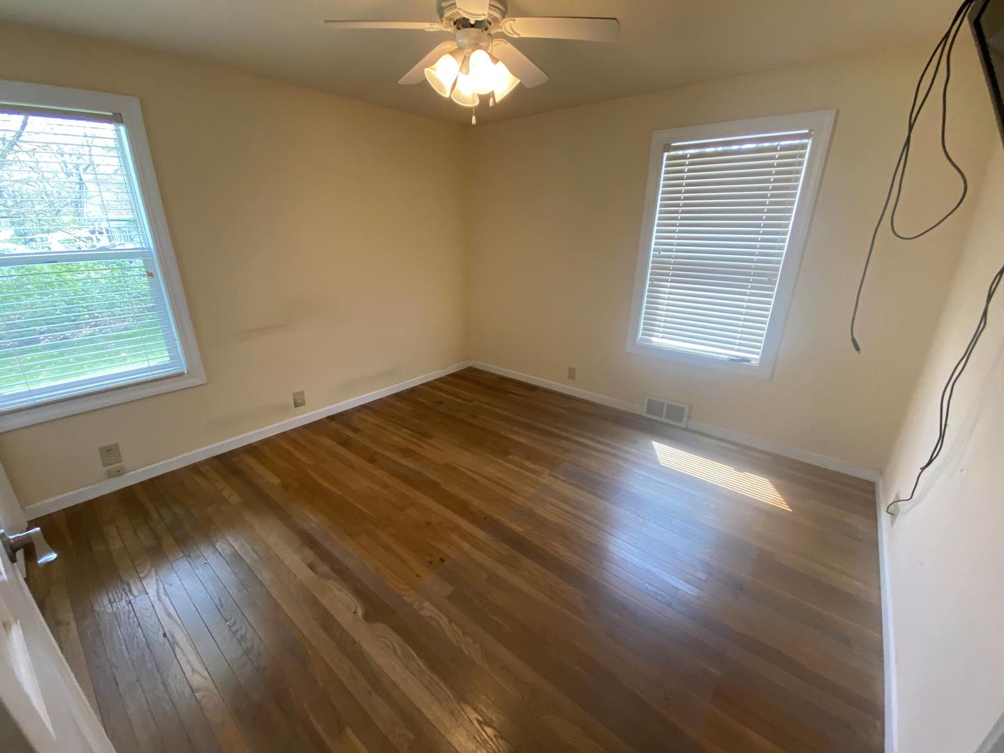 11270 Bell Road Lemont, IL 60439 - Photo 5 of 23 a view of an empty room with wooden floor and a window
