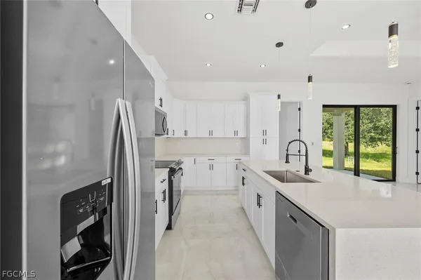 a large white kitchen with a large window
