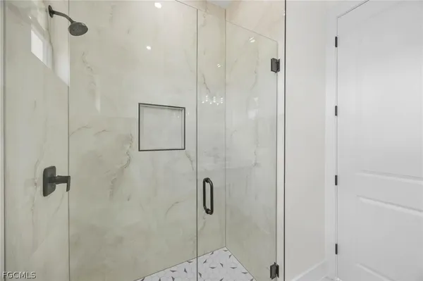a bathroom with a shower and a glass door