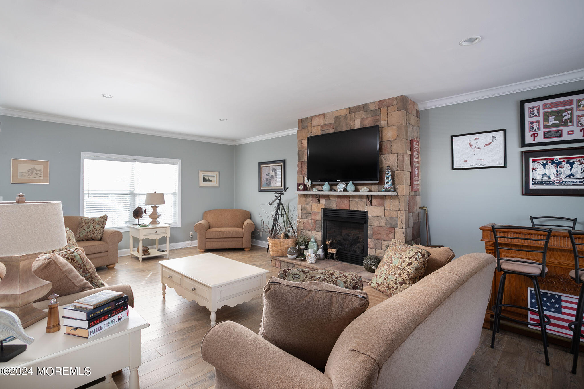 27 Sands Point Road Waretown, NJ 08758 - Photo 11 of 36 a living room with furniture a fireplace and a flat screen tv