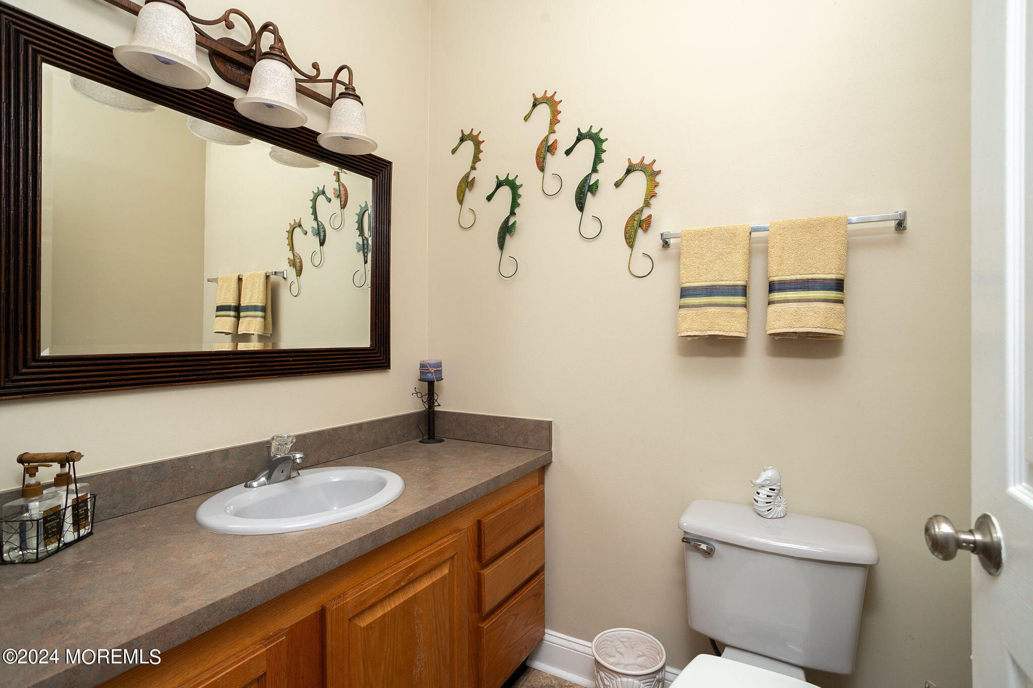 27 Sands Point Road Waretown, NJ 08758 - Photo 19 of 36 a bathroom with a granite countertop sink and a mirror