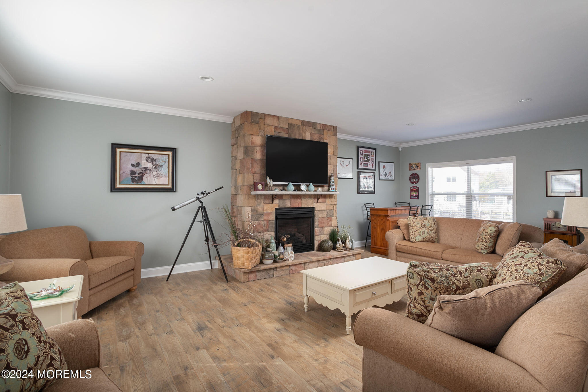 27 Sands Point Road Waretown, NJ 08758 - Photo 10 of 36 a living room with furniture a fireplace and a flat screen tv
