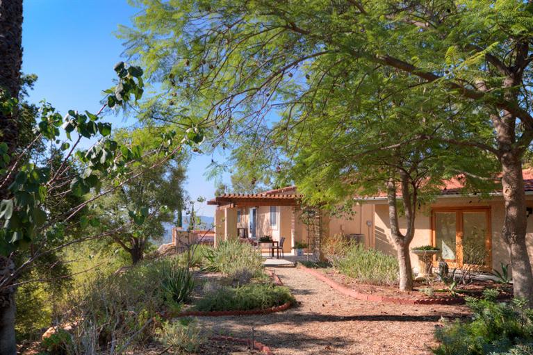 1496 Foothill Road Ojai, CA 93023 - Photo 4 of 30 a front view of a house with garden
