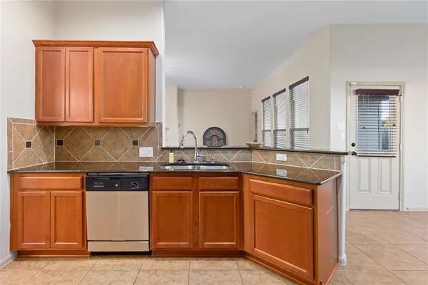 a kitchen with stainless steel appliances granite countertop a sink stove and cabinets