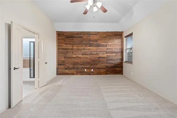 a view of an empty room with a ceiling fan