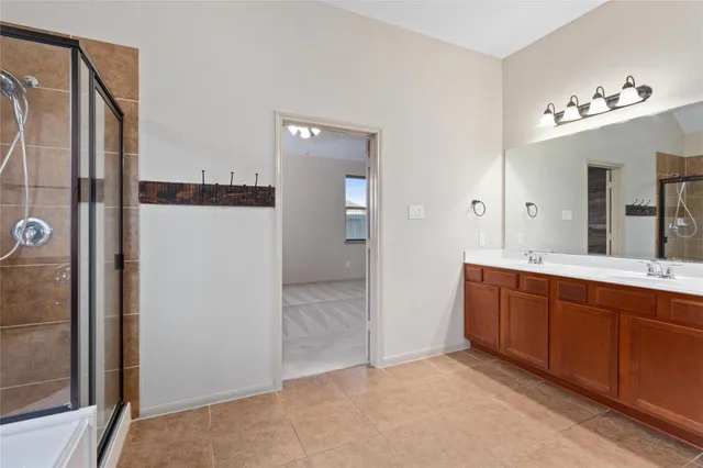 a spacious bathroom with a mirror sink and shower