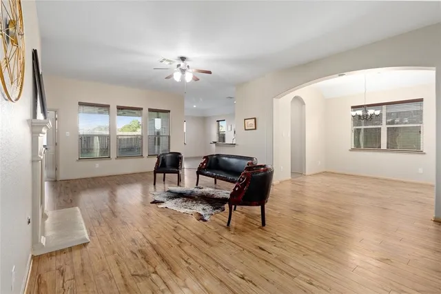 a living room with furniture and a wooden floor