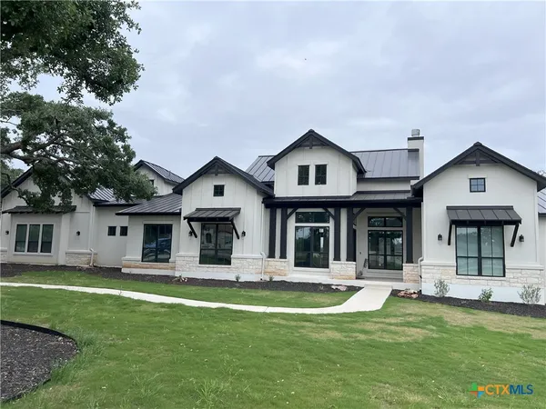a view of a house with swimming pool and porch