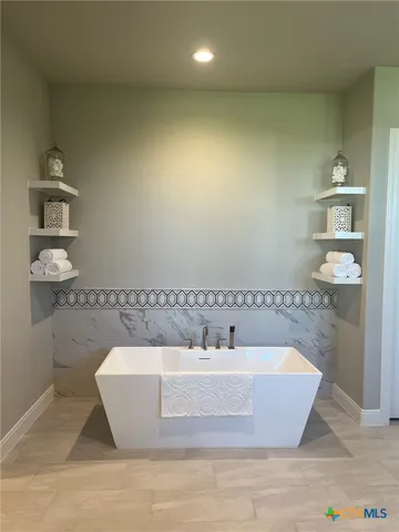 a white bath tub sitting in a bathroom