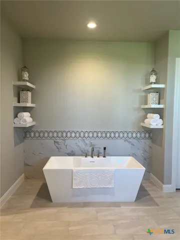 a white bath tub sitting in a bathroom