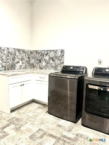 a kitchen with a stove top oven and cabinets
