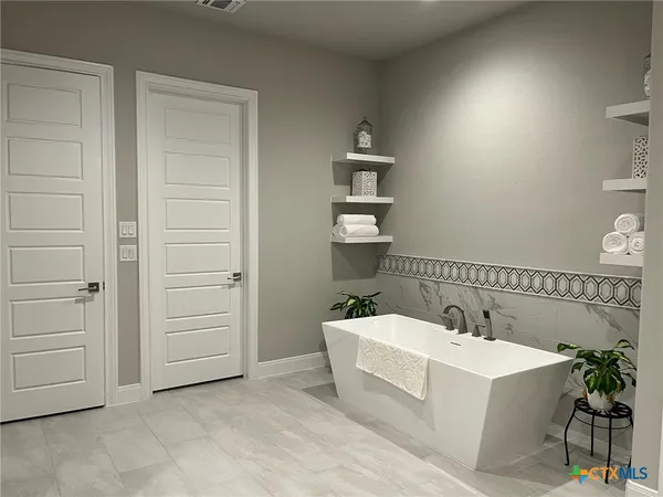 a bathroom with a sink a large mirror and a bathtub