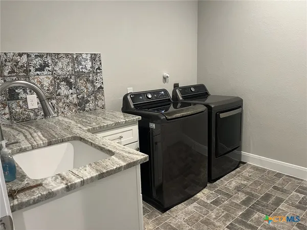 a view of kitchen with wooden floor and cabinets