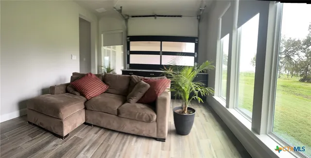 a living room with furniture and a large window