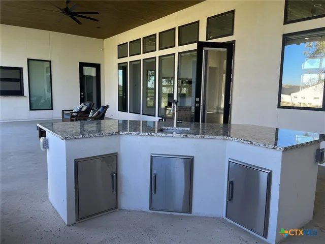 a kitchen with a sink and a mirror
