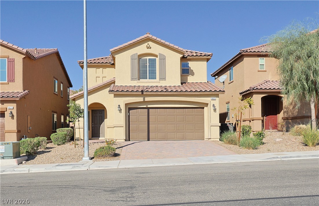 8663 Reynolds Spring Street Las Vegas, NV 89178 - Photo 3 of 32 Spanish tile roofing and custom shutters enhance this two-story desert home.