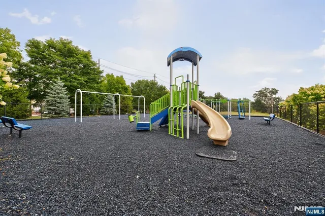 a view of outdoor space with playground and green space