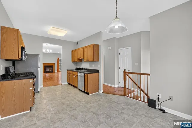 a open kitchen with cabinets a sink and a stove