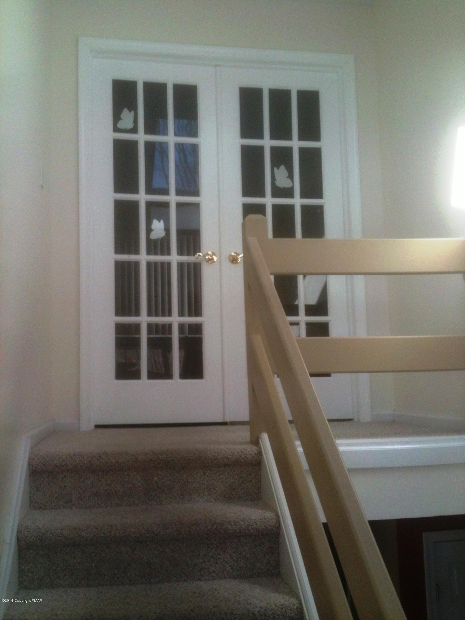 26 Lily Road East Stroudsburg, PA 18302 - Photo 12 of 48 a view of staircase with white walls and a window