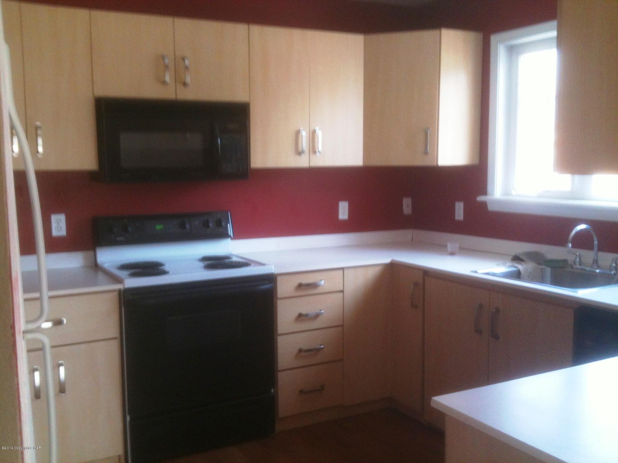 26 Lily Road East Stroudsburg, PA 18302 - Photo 16 of 48 a kitchen with a sink and a microwave