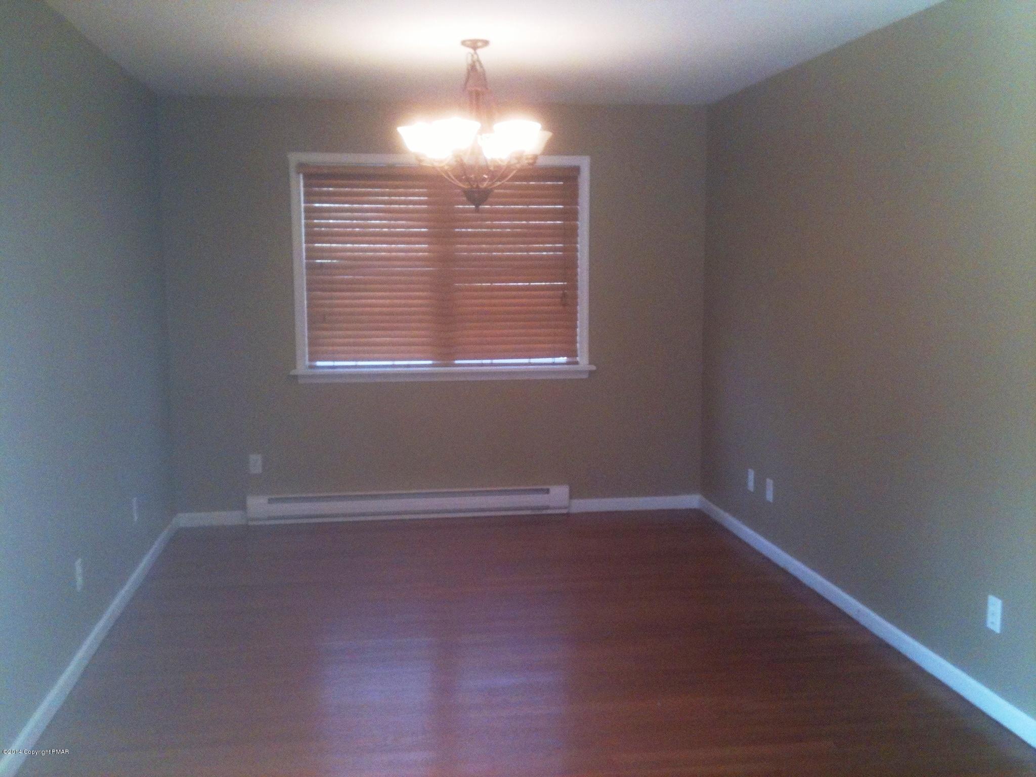 26 Lily Road East Stroudsburg, PA 18302 - Photo 22 of 48 en empty room with windows and chandelier fan