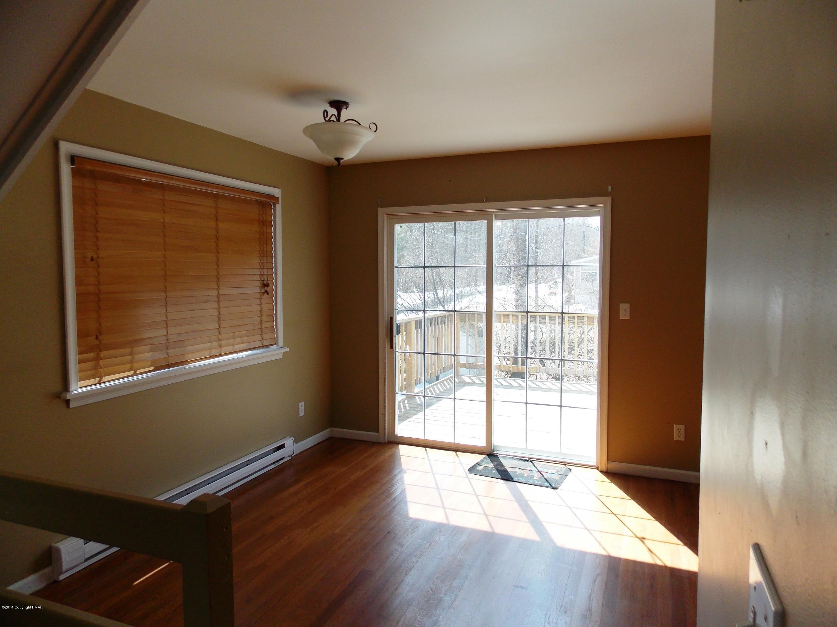 26 Lily Road East Stroudsburg, PA 18302 - Photo 40 of 48 a view of an empty room with wooden floor and a window