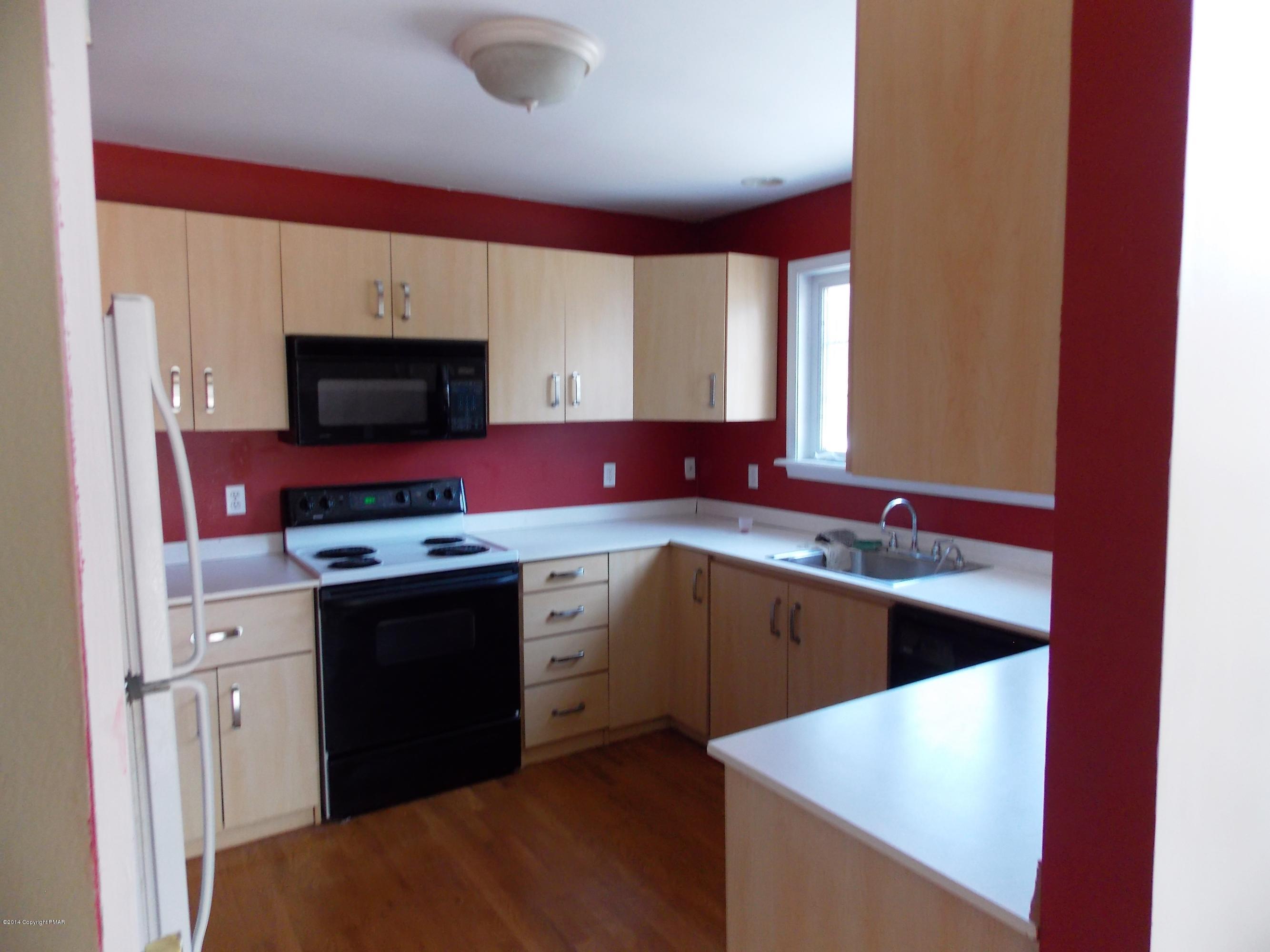 26 Lily Road East Stroudsburg, PA 18302 - Photo 41 of 48 a kitchen with stainless steel appliances granite countertop a sink stove and refrigerator