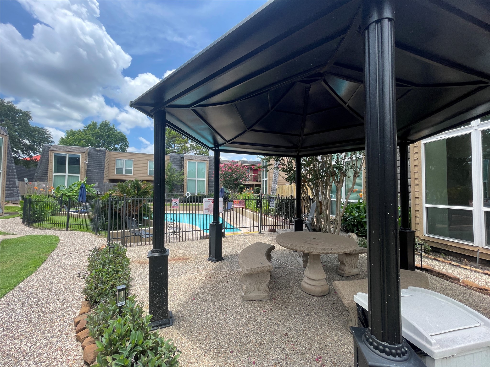 16120 Stuebner Airline Road, Unit 601 Spring, TX 77379 - Photo 11 of 12 a view of a porch with chairs and backyard