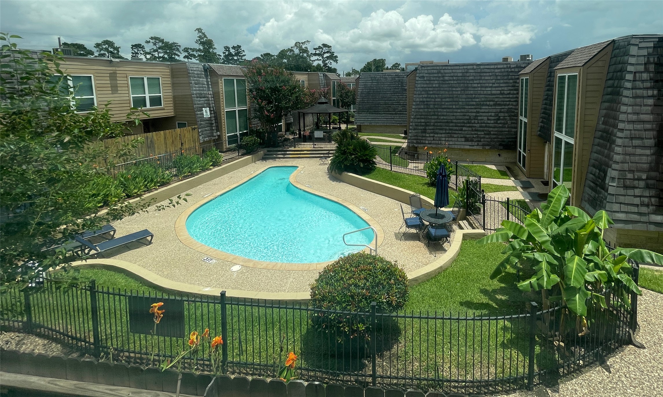 16120 Stuebner Airline Road, Unit 601 Spring, TX 77379 - Photo 12 of 12 an aerial view of a house with swimming pool and garden
