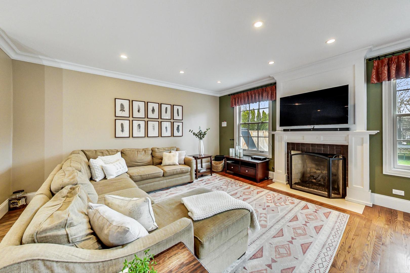 615 Windsor Road Glenview, IL 60025 - Photo 15 of 51 a living room with furniture a fireplace and a flat screen tv