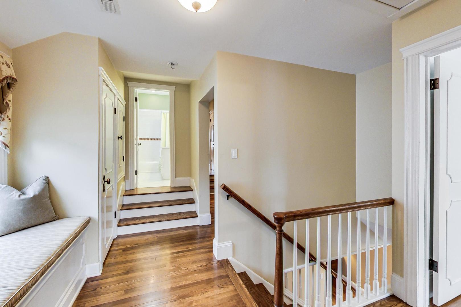 615 Windsor Road Glenview, IL 60025 - Photo 19 of 51 a view of a hallway with wooden floor and furniture