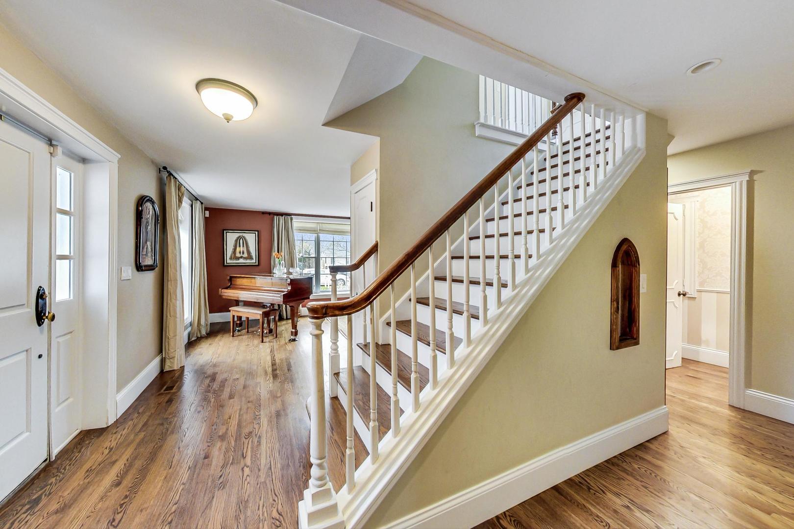 615 Windsor Road Glenview, IL 60025 - Photo 2 of 51 a view of entryway with wooden floor and stairs