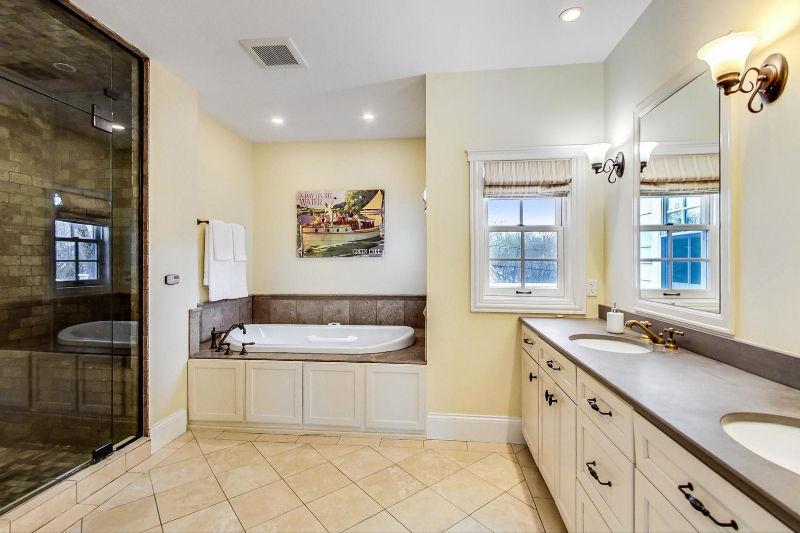 615 Windsor Road Glenview, IL 60025 - Photo 26 of 51 a spacious bathroom with a tub sink and mirror