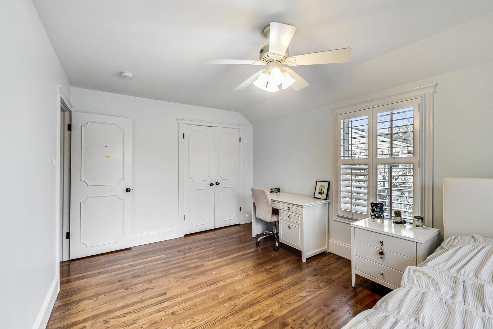 615 Windsor Road Glenview, IL 60025 - Photo 31 of 51 a room with a bed and wooden floor