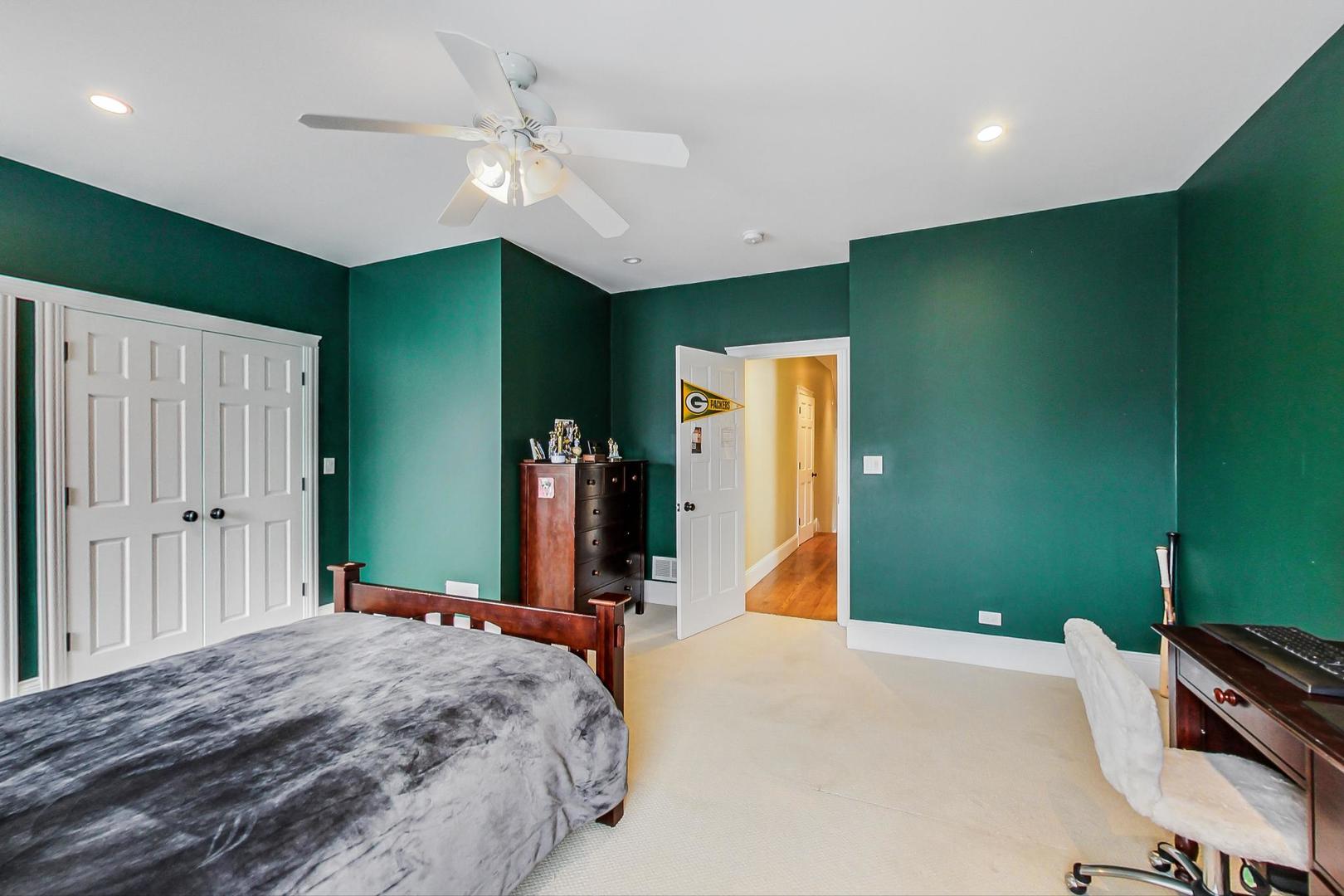 615 Windsor Road Glenview, IL 60025 - Photo 37 of 51 a bedroom with a bed and a chandelier