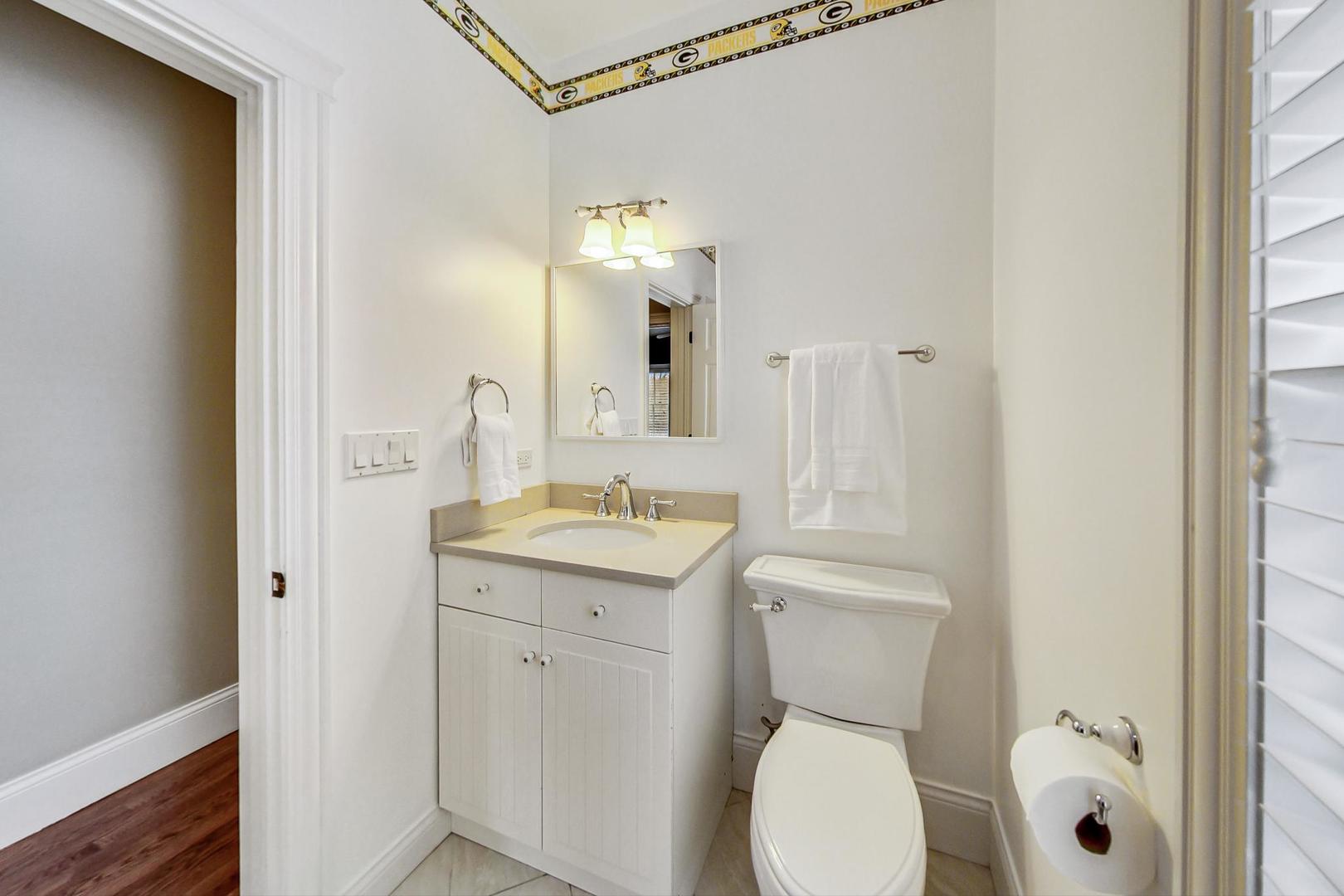 615 Windsor Road Glenview, IL 60025 - Photo 38 of 51 a bathroom with a toilet a sink and mirror