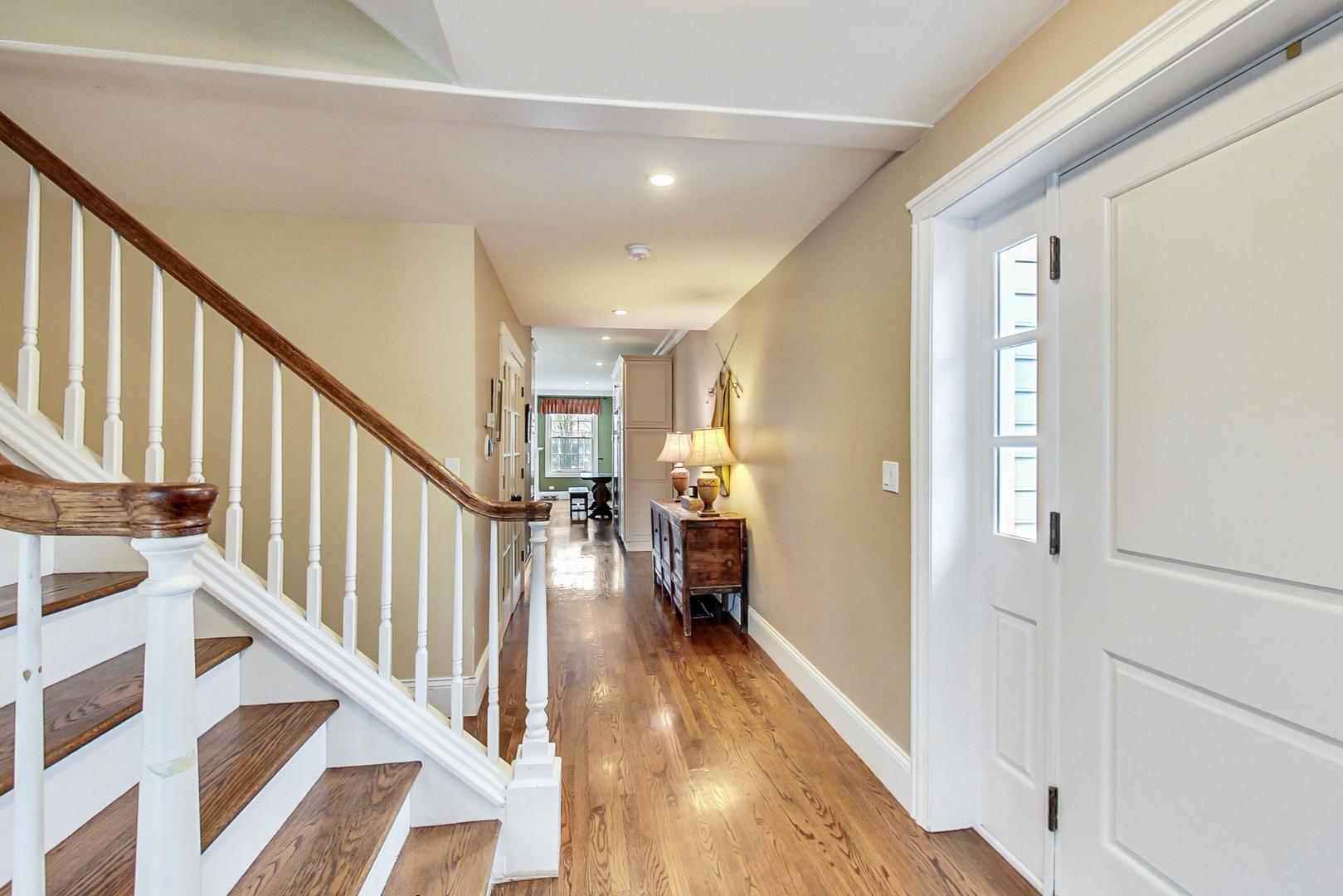 615 Windsor Road Glenview, IL 60025 - Photo 5 of 51 a view of a hallway with wooden floor and stairs