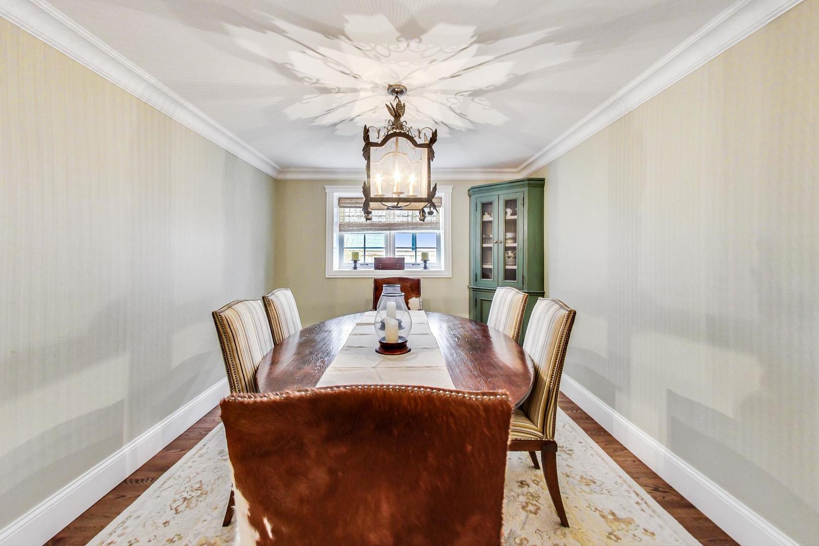 615 Windsor Road Glenview, IL 60025 - Photo 6 of 51 a dining room with furniture a chandelier and wooden floor