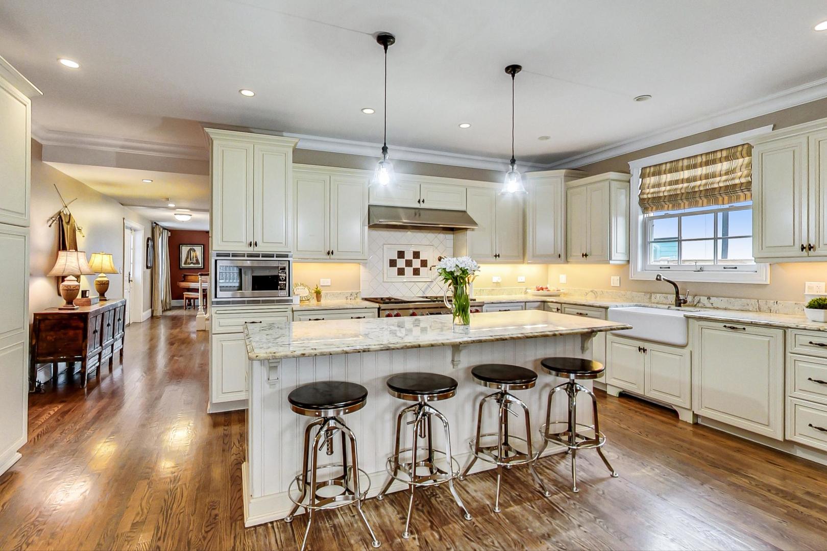 615 Windsor Road Glenview, IL 60025 - Photo 8 of 51 a kitchen with sink cabinets and wooden floor