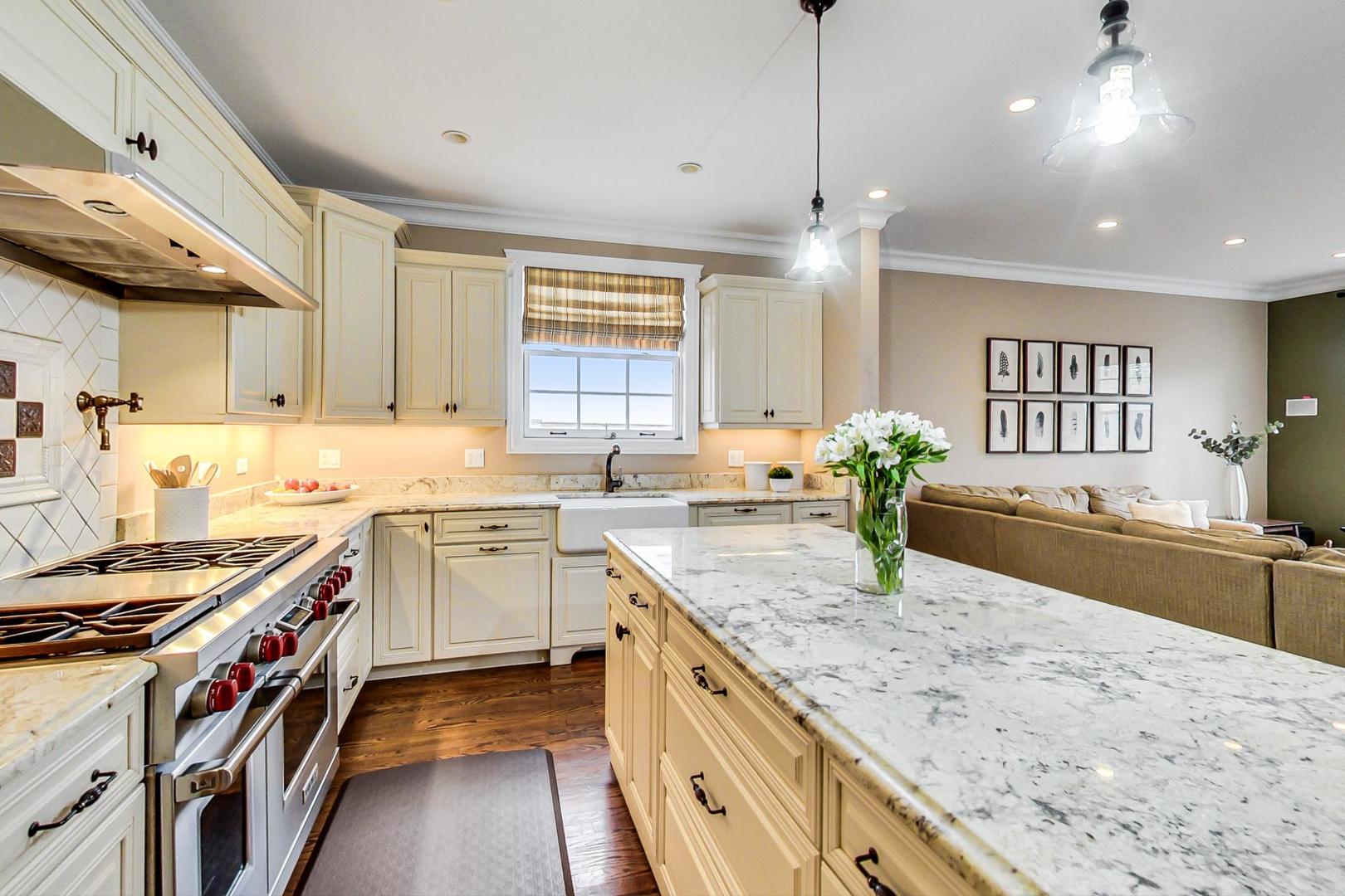 615 Windsor Road Glenview, IL 60025 - Photo 9 of 51 a kitchen with stainless steel appliances granite countertop a sink stove and cabinets