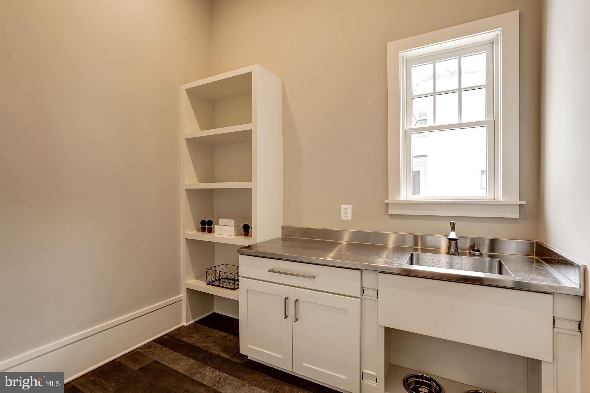 6166 Cobbs Road Alexandria, VA 22310 - Photo 25 of 30 Laundry Room with built-in shelving and cabinets