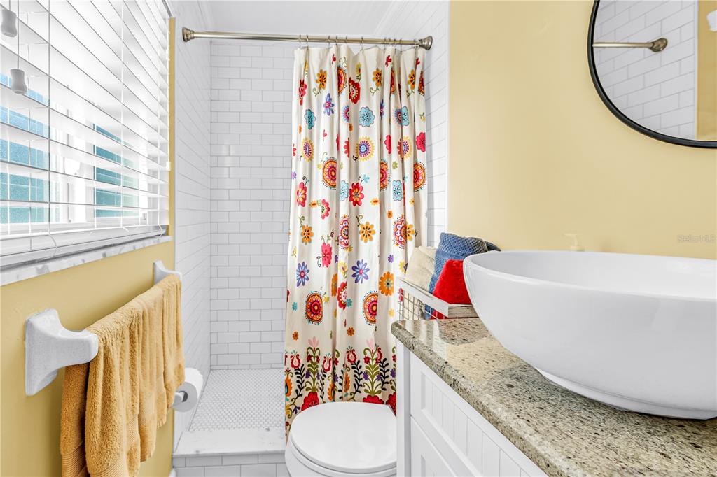 10020 Panama Court Seminole, FL 33776 - Photo 12 of 25 a bathroom with a granite countertop sink and a mirror