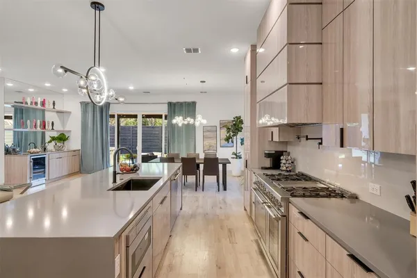 a living room with furniture kitchen and a wooden floor