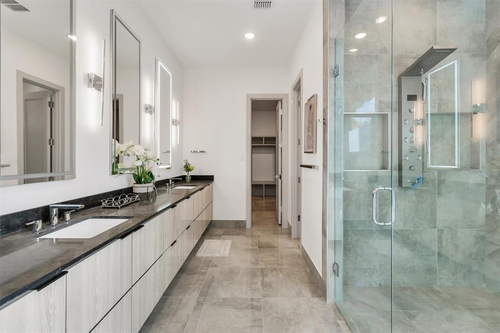 7519 Robin Road Dallas, TX 75209 - Photo 17 of 40 Full bathroom with double vanity, a shower stall, a walk in closet, and recessed lighting