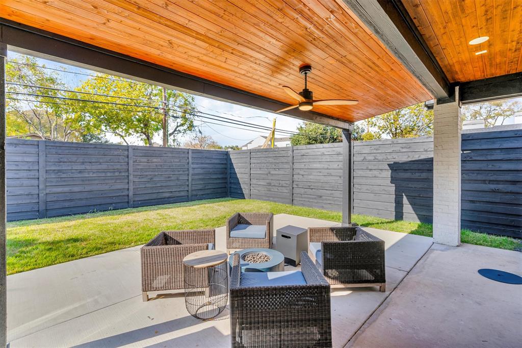 7519 Robin Road Dallas, TX 75209 - Photo 3 of 40 Fenced backyard with a patio area, ceiling fan, and an outdoor living space with a fire pit