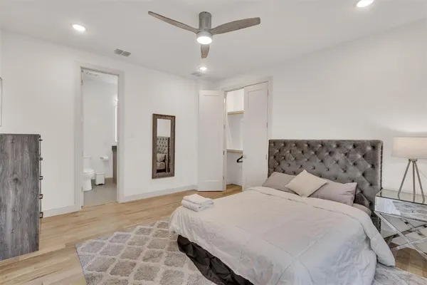 a bedroom with a large bed and a rug